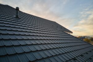 close up of house roof covered in dark ceramic shingles